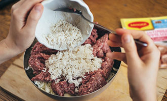 Cuối cùng, cho thịt băm và cơm vào tô cùng các nguyên liệu, không cần chắt nước. Thêm một chút muối và hạt tiêu, sau đó nhào kỹ thịt băm từ các nguyên liệu. Mọi thứ nên trở nên đồng nhất.
