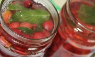Turnați siropul fierbinte înapoi în borcanele cu agrișe și mentă.
