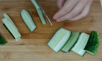 Hoe maak je Koreaanse komkommers klaar voor de winter in potten? Behandel de komkommers met een borstel zodat er geen doornen zijn, snijd de uiteinden af ​​en was ze. Snijd de komkommers in grote reepjes. Als ze overrijp zijn, verwijder dan de zaden.