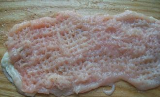 Com cuinar rotllos de pollastre amb farcit al forn? Primer cal esbandir el filet de pollastre sota aigua corrent i assecar-lo una mica amb una tovallola de paper. Agafeu un ganivet afilat i talleu amb cura cada filet longitudinalment en dos trossos d'aproximadament el mateix gruix. Cobrir cada meitat amb paper film i batre una mica.