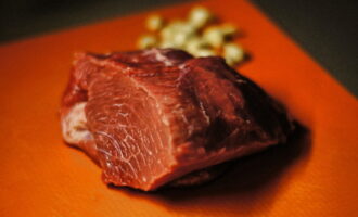 Cum se coace carne de vită suculentă în folie în cuptor? Se spala bine carnea si se usuca cu prosoape de hartie, se indeparteaza eventualele pelicule. Curățați usturoiul, clătiți și tăiați în felii subțiri. Tăiați și untura în felii subțiri.
