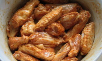 Ngayon ay idagdag ang mga buto-buto ng manok sa inihandang marinade at pukawin hanggang ang mga piraso ay ganap na natatakpan ng sarsa. Ilagay ang karne sa refrigerator para ibabad sa marinade ng 1 oras.