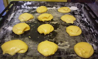 Espolvorear una safata de forn amb farina, col·locar-hi porcions de massa a distància una de l'altra.