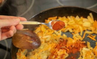 En una paella a part, sofregiu les cebes i les pastanagues, afegiu el pebre vermell a les verdures. 