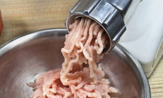 Tvätta kycklingbröstet under rinnande vatten och torka ordentligt med hushållspapper. Skär ingrediensen i stora bitar och mal den med en köttkvarn.
