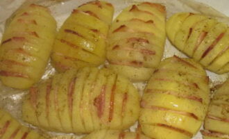 Passat el temps especificat, talleu amb cura la màniga i torneu les patates al forn perquè es daurin durant cinc o deu minuts més. Al mateix temps, augmenta la temperatura del forn a 220 graus.