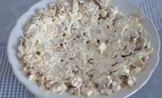 Incepem sa formam salata. Punem carnea in primul strat si o imbracam cu maioneza.
