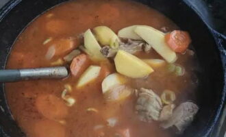 Pagkatapos ng 10 minuto, idagdag ang mga patatas na hiwa sa mga hiwa, at pagkatapos ng 30 minuto magdagdag ng kumin, itim na paminta, turmerik, asin at bay leaf.