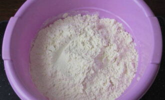 Rây 450 gam bột mì (dành 50 gam để rắc bột) qua rây mịn cho vào hộp sâu.