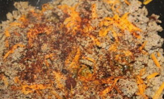 Fregiu la carn picada en una paella a part.Afegiu-hi una pastanaga, ratllada amb un ratllador gruixut, espècies, sal, barregeu-ho tot bé i continueu fregint fins que la carn picada estigui llesta durant uns 10-15 minuts.