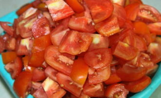 Ang salad na may bigas para sa taglamig ay napakasimpleng ihanda. Ihanda kaagad ang lahat ng mga gulay at pampalasa ayon sa recipe. Linisin ang mga ito at banlawan sa ilalim ng tubig na tumatakbo.Ang mga kamatis, mas mabuti na may malakas na sapal, gupitin sa maliliit na piraso ng anumang hugis.