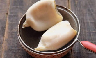 Després de la cocció, poseu immediatament els calamars en un colador i esbandiu-los amb aigua freda. Deixeu que el líquid s'escorre completament.
