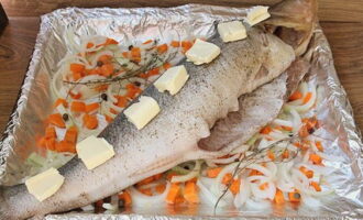 Lägg bitar av smör på ytan av fisken. Täck arbetsstycket med folie och placera det i en ugn som är förvärmd till 180 grader i 40-60 minuter.