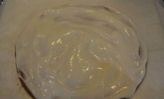 Para sa cream, talunin ang sour cream, asukal at vanillin hanggang makinis. Pahiran ng cream ang unang layer ng cake.