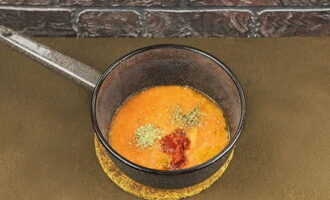 Verhit de olijfolie in een pan met dikke bodem en giet de tomatenpulp erbij; voeg voor de smaak gedroogde kruiden toe - oregano en basilicum, geperste knoflook en een lepel tomatenpuree. 