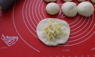 Rol elke bal deeg uit en plaats een beetje koolvulling in het midden van het flatbread.