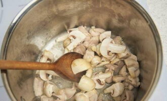 Init ang langis ng gulay sa isang kasirola at iprito ang mga magaspang na tinadtad na mushroom, pati na rin ang tinadtad na pulp ng manok.