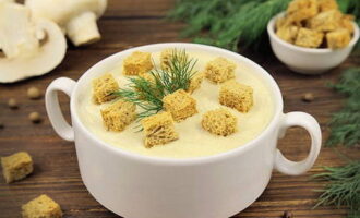 Súp nấm kem cổ điển với kem đã sẵn sàng. Phục vụ, phủ bánh mì nướng và một nhánh rau thơm.