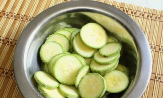 Đặt bí xanh vào một cái bát lớn, rắc muối và đợi nửa giờ để loại bỏ chất lỏng dư thừa.