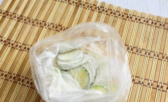 Đổ bột vào túi và đặt bí xanh vào đó. Sau khi buộc túi, lắc đều để bí xanh được phủ đều bột mì.