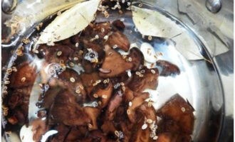 După 10 minute de gătit, adăugați sare, zahăr și condimente. Fierbe totul împreună timp de 15 minute. Adăugați aici căței de usturoi, turnați ulei vegetal și oțet. Se fierbe 5 minute.