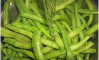 Ilagay ang beans sa isang colander. Hugasan namin ito ng tubig at suka. Makakatulong ito na mapanatili ang makulay na berdeng kulay ng beans.