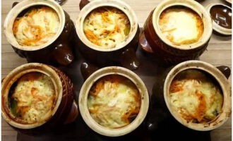 Acoperiți vasele cu capace, puneți-le la cuptorul rece și porniți la 190-200°C. Coaceți vasul timp de o oră. Verificați starea de pregătire a cartofilor cu un cuțit. Serviți cartofii fierbinți cu pui și ciuperci fierte la cuptor într-o oală. Poftă bună! 