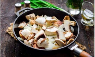 Voeg vervolgens de champignons en kruiden toe, meng en kook nog 5-7 minuten op matig vuur.