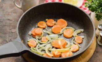 I en stekpanna med vegetabilisk olja, stek löken och morötterna i cirka 3 minuter.