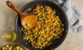 Häll mer vegetabilisk olja i samma stekpanna och värm upp den. Släng i morötterna. Efter stekning i 5 minuter, tillsätt pickles. Fortsätt tillagningen och ta bort från värmen efter 5 minuter.