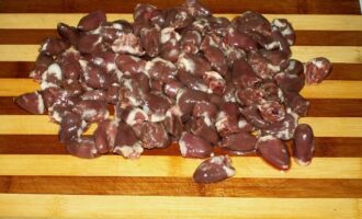 Inimioarele de pui la tigaie sunt foarte usor de preparat. Această mică listă de produse va fi un preparat fierbinte excelent pentru prânz sau cină. Spălați bine inimile, îndepărtați vasele de sânge, cheagurile de sânge și grăsimea.