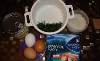 Paano gumawa ng klasikong crab salad? Ihanda natin ang mga produkto ayon sa listahan. Para sa salad, maaari mong gamitin ang parehong crab meat at crab sticks. Pakuluan ang mga itlog ng manok at kanin hanggang maluto nang maaga. Pinong tumaga ang dill gamit ang isang kutsilyo.