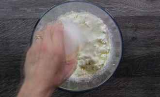 Sikta den nödvändiga mängden mjöl i kesoen genom en sil, tillsätt socker och salt.